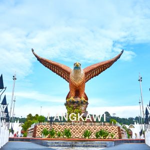 A sculpture of a red eagle spreading its wings. Popular tourist spot on Langkawi island. Langkawi, Malaysia - 06.21.2020